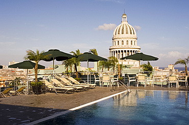 A swimming pool on the roof terrace of the Hotel Saratoga overlooking the Capitolio in central Havana, Cuba, West Indies, Central America