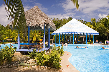 Swimmers in the pool at the Hotel Melia Rio de Oro on the Playa Esmeralda, Carretera Guardalavaca, Eastern Cuba, Cuba, West Indies, Central America