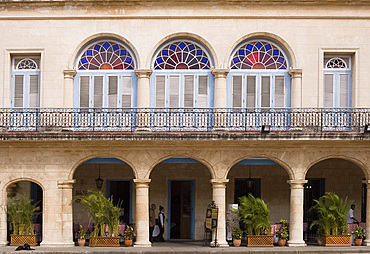 Shutters, columns and stained glass windows on the front of the Hotel Santa Isabel, Plaza de Armas, Habana Viejo,Havana, Cuba, West Indies, Central America