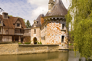 The chateau of St.-Germanine-de-Livet with a colourful checked facade and half timbered 15th century wing, Normandy, France, Europe