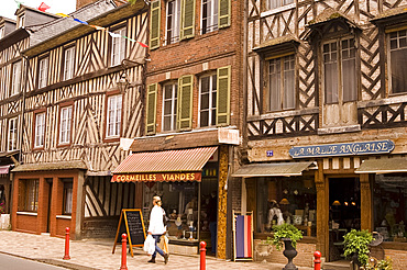 Shops and half timbered buildings on the main street of Cormeilles, Normandy, France, Europe