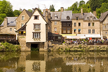 Waterfront cafes next to medieval timber and stone buildings in Port du Dinan on the River Rance, Dinan, Brittany, France, Europe