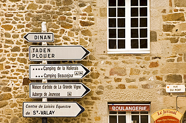 Road signs in front of an old stone house in Port du Dinan, Brittany, France, Europe