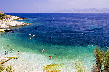 Swimmers at a small beach near Kassiopi, northeast coast, Corfu, Ionian Islands, Greek Islands, Greece, Europe