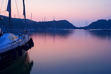 Sailboats in harbour at dusk, Lakka, Paxos, Ionian Islands, Greek Islands, Greece, Europe