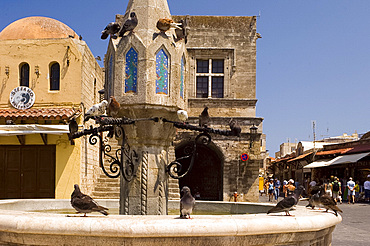 Pigeons on a fountain in Rhodes Town, Rhodes, Dodecanese, Greek Islands, Greece, Europe