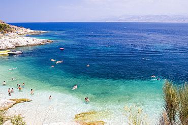 Swimmers in the sea near Kassiopi, northeast coast, Corfu, Ionian Islands, Greek Islands, Greece, Europe