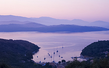 A view looking down on the harbour of Ayios Stefanos at sunrise, northeast coast, Corfu, Ionian Islands, Greek Islands, Greece, Europe