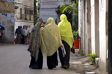 Women wearing colourful headscarves walking in Stone Town, Zanzibar, Tanzania, East Africa, Africa