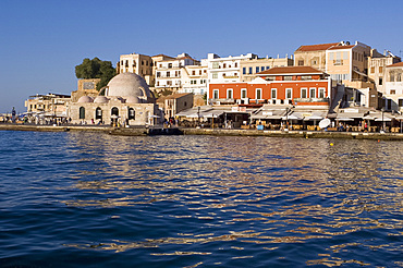 A view of tavernas around the harbour and the Kutchuk Hasan Mosque in the old town section of Hania (Chania) (Xania), Crete, Greece, Europe