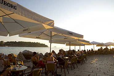 People enjoying sunset at outdoor cafes in Rovinj, Istria, Croatia, Adriatic, Europe