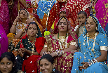 Women wearing colourful saris at the Mewar Festival on Lake Pichola, Udaipur, Rajasthan, India, Asia