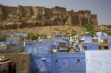 The Mehrangarh Fort on a hilltop overlooking the blue houses of Jodhpur, Rajasthan, India, Asia