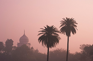 A misty silhouette at sunrise of the Gurdwar Dam Dama Sahib from the garden at Humayun's Tomb, New Dehli, India, Asia