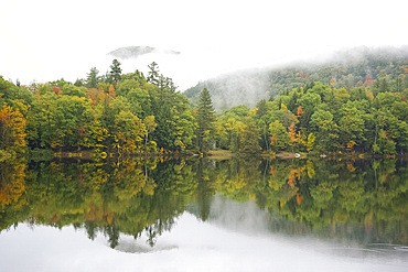 Mist rising over hills and autumn foliage around the Woodward Reservoir in central Vermont, New England, United States of America, North America