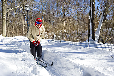 A woman on cross country skis in Central Park after a blizzard, New York City, New York State, United States of America, North America