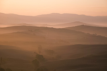 A dawn view over the misty hills of Val d'Orcia, UNESCO World Heritage Site, Tuscany, Italy, Europe