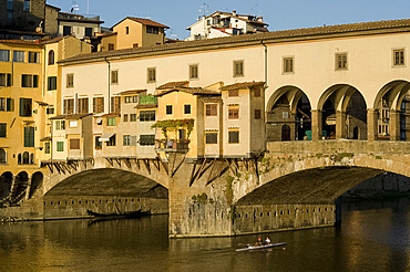 Rowers on the Arno River and gondolas moored underneath the Ponte Vecchio, Florence, UNESCO World Heritage Site, Tuscany, Italy, Europe