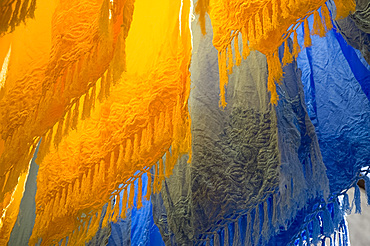 Brightly coloured dyed fabrics hanging to dry in the dyers souk, Marrakech, Morocco, North Africa, Africa