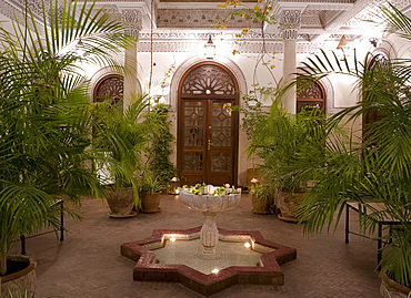 An interior courtyard featuring a marble fountain and palm trees at the Villa des Orangiers in Marrakech, Morocco, North Africa, Africa