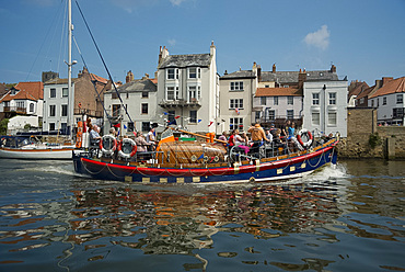 A colourful wooden sightseeing boat in Whitby Harbour in Yorkshire, England, United Kingdom, Europe