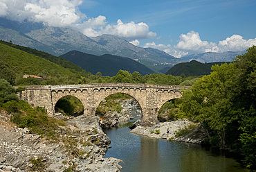 The Genoese Bridge, a stone arched bridge over the river Porto near Porto, Corsica, France, Europe