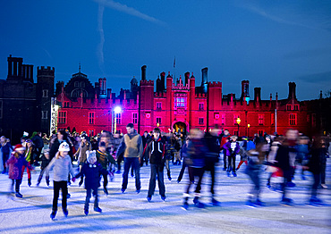 A skating rink in front of Hampton Court Palace lit with red lights, Greater London, England, United Kingdom, Europe