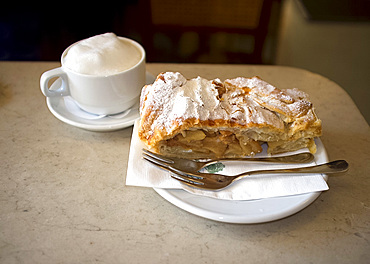 Apple strudel and cappuccino served in the Tomaselli Cafe in the Altstadt, Salzburg, Austira, Europe