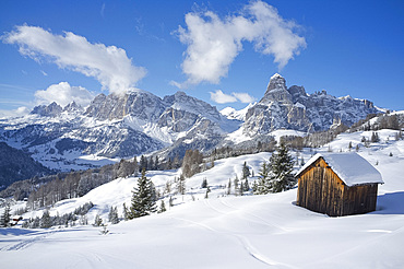 Mounts Lavarella, Conturines and Sasongher behind a snow covered wooden barn at the Alta Badia ski resort, Corvara, Dolomites, South Tyroll, Italy, Europe