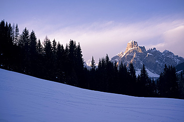 The last run, a view of Sassongher mountain at sunset from a piste at Alta Badia ski resort, Dolomites, South Tyrol, Italy, Europe