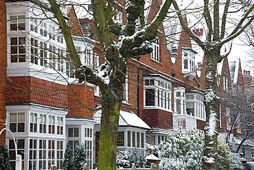 Snow falling in front of Arts and Crafts style houses in Bedford Park, London, England, United Kingdom, Europe