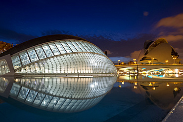 The Hemisferic building and Palace of Arts Reina Sofia in the Arts and Science Center at dusk mirrored in a reflecting pool, Valencia, Spain, Europe