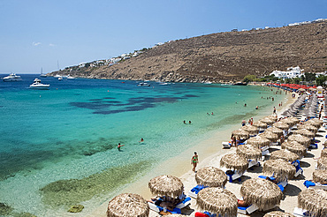 Thatched umbrellas on Ornos Beach on Mykonos, The Cyclades, Greek Islands, Greece, Europe