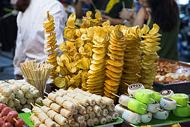 Chips and rolls on skewers at a night market in the Old Quarter of Hanoi, Vietnam, Indochina, Southeast Asia, Asia