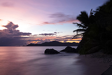 Sunset at Anse Source d'Argent looking toward Praslin, Union Estate Park, La Digue, Seychelles, Indian Ocean, Africa