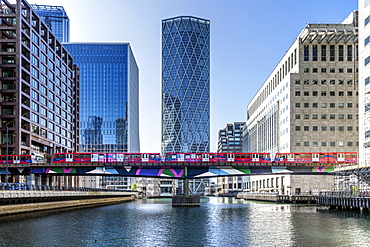 Dockland Light Railway (DLR) train crossing Middle Dock at Canary Wharf, Docklands, London, England, United Kingdom, Europe