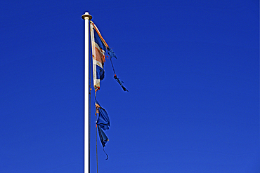 Torn Union Jack as symbol of economic decline