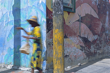 Woman walking in Anse La Raye, St. Lucia, Windward Islands, West Indies, Caribbean, Central America