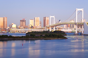 Tokyo Tower and the skyline of central Tokyo illuminated at sunrise, Rainbow Bridge, Odaiba, Tokyo Bay, Tokyo, Honshu, Japan, Asia