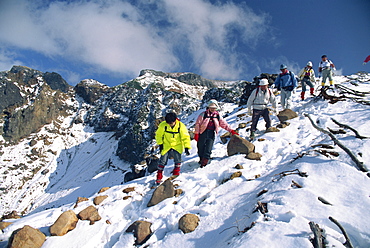 A group of hikers descending on Mount Furanodake in the autumn, on the island of Hokkaido, Japan, Asia