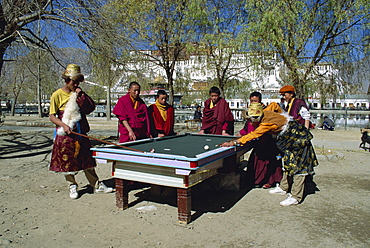 Locals playing pool with Potala Palace in background, Lhasa, Tibet, China, Asia