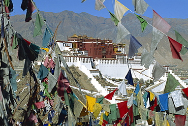 The Potala palace, UNESCO World Heritage Site, seen through prayer flags, Lhasa, Tibet, China, Asia