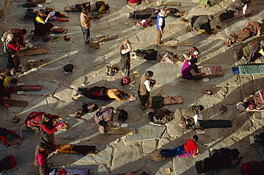 Pilgrims prostrating, Jokhang Temple, Barkhor, Lhasa, Tibet, China, Asia