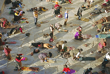 Buddhist pilgrims prostrating, Barkhor Jokhang Temple, Lhasa, Tibet, China