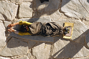 Pilgrim prostrating, Jokhang Temple, Barkhor, Lhasa, Tibet, China, Asia