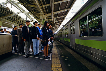 Passengers on platform and train, Tokyo station, Tokyo, Japan, Asia