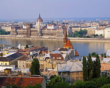 Houses and church in Buda with the River Danube beyond and the Parliament Building in Pest in Budapest, Hungary 