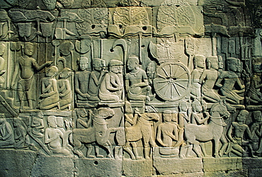 Stone bas-reliefs depicting scenes of rural life and historical events, in the Bayon Temple complex, Angkor, Siem Reap, Cambodia