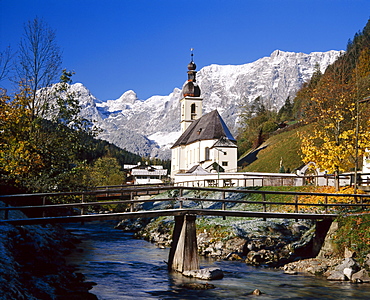 Wooden bridge in front of the church at Ramsau in the mountains of Bavaria, Germany 