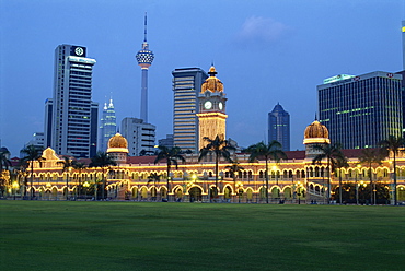 City skyline and the Sultan Abdul Samad Building illuminated at dusk, seen from Merdeka Square, Kuala Lumpur, Malaysia, Southeast Asia, Asia